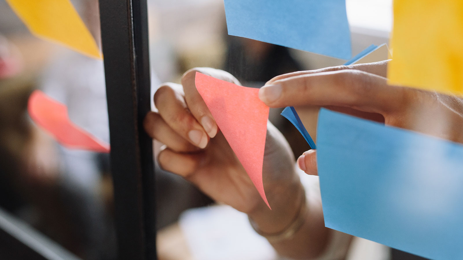 Brainstorming session with sticky notes on a window for digital marketing strategy